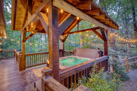Relax and unwind in the hot tub or rocking chair, beautifully lit outdoors