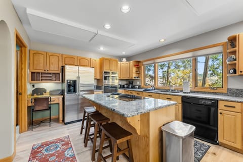 Kitchen: Drip coffee maker, Crockpot, blender, cooking utensils, tableware, griddle