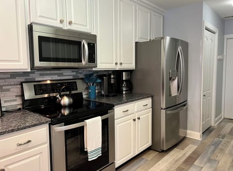 Stainless steel appliances, two different coffee machines, and other essentials.