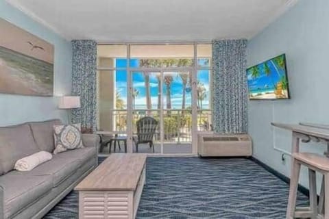 Spacious living room with walk-out 1st-floor balcony, ocean views, and easy access to all resort ame