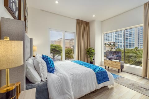 This bedroom comes has a king size bed, a television, and a large window that allows natural light to get in. The large curtains provide peace and privacy while you sleep.