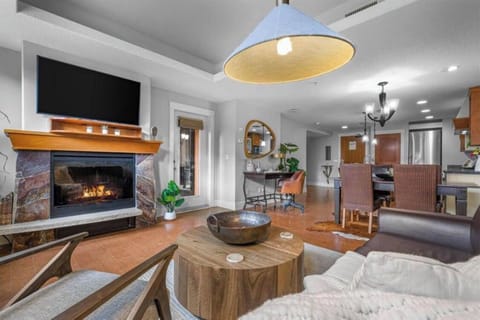 Living Room Area with Electric Fireplace and TV.  Deck Access from Living room