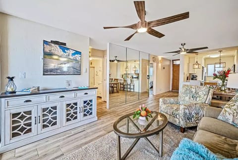Living room features dual fans, 60-inch SMART TV, and beautiful ocean views.