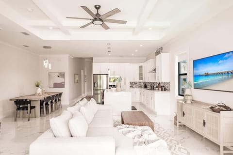All three spaces: living, dining, and kitchen are close enough for guests to enjoy each other's company. | Coastal Sol by Boutiq Luxury Vacation Rentals | Naples, Florida