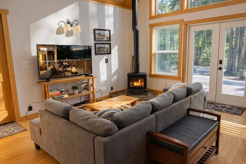 This cozy living room invites you to unwind with plush seating, propane fireplace, and entertainment for perfect evenings in.