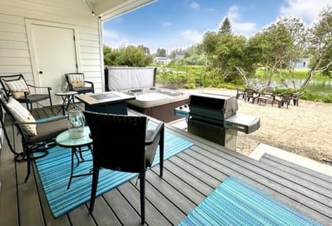 Enjoy the sandy backyard and covered back patio overlooking the Grand Canal.