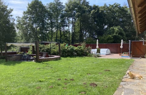 Fenced in yard with swimming, pool, and seating area & play area
