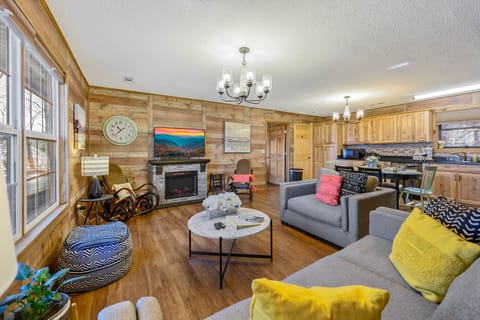 Open concept living room and kitchen with plenty of comfy seating and fireplace