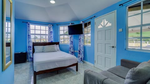 Bedroom with view of door leading to balcony