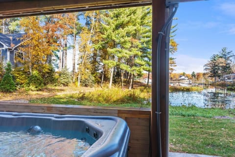 Covered patio jacuzzi offering peaceful views of the autumn landscape.