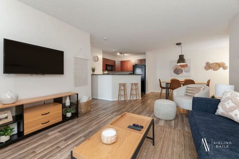 Living room with a smart TV, walkout access to the ground-floor patio, cozy seating options and a queen-sized pull-out sleeper sofa (all bedding provided.)
