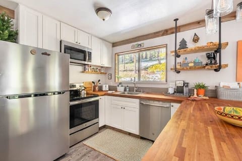 Modern kitchen with microwave, dishwasher, stove, fridge & garbage disposal