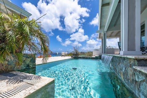 The spacious pool deck with incredible views, wifi, sun loungers, and 2 covered sitting areas.