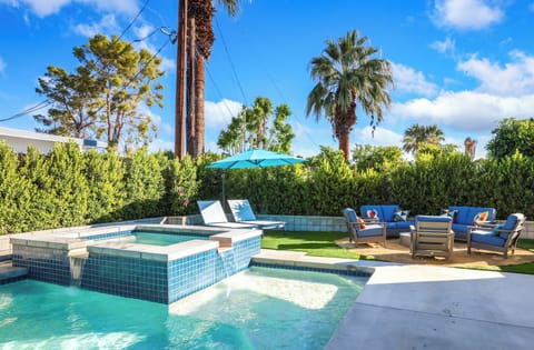 Resort-style pool and spa with lounge chairs and private yard