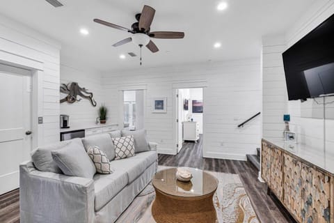 Comfortable living room w/ sectional seating, TV & warm wood accents.