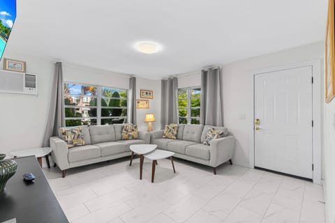 Large well lit living room with 65 inch smart TV.