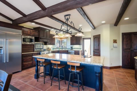 Chefs kitchen with counter bar.