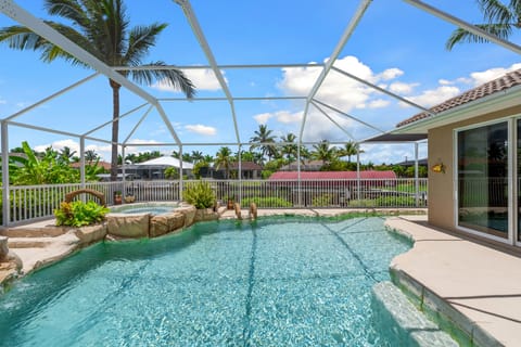 Heated pool with cascading hot tub