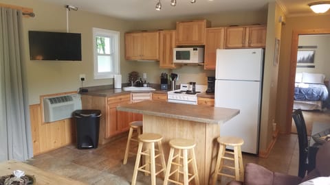 Fully stocked kitchen with island and smart TV