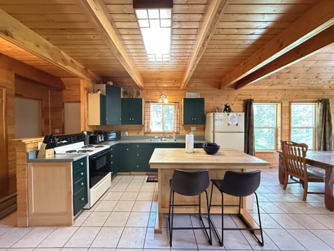 Full kitchen with island to prepare food. Appliances, basic spices, dishes, and silverware are provided.