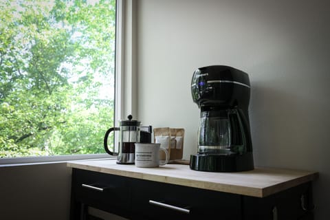 Coffee bar featuring a drip coffee maker and French press.