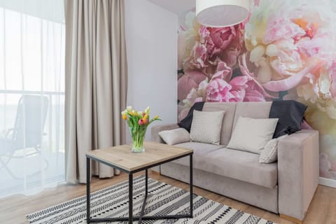 The living room features a sleek coffee table and a flat-screen television.