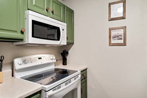 The kitchen is stocked with all the essentials - cutlery, plates, bowls, pots, pans and basic cookware. 