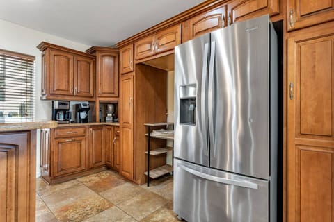 Full-size stainless steel refrigerator and coffee station ensure guests feel right at home during extended stays.