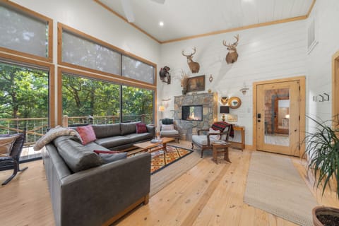 Living Room: Enjoy sharp, panoramic views from stylish seating and a warm stone fireplace!