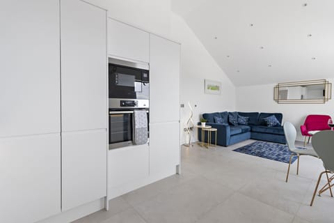 Open plan kitchen with AEG electric oven, microwave and integrated fridge & freezer