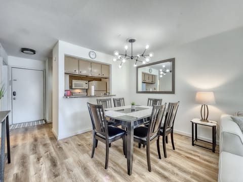 The dining area includes a large 6 person solid wood dining table