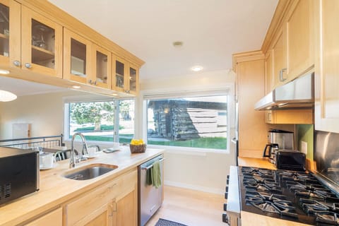 Updated kitchen with stainless steel appliances, gas stovetop, and butcher block counters, adding country charm perfect for families and guests.