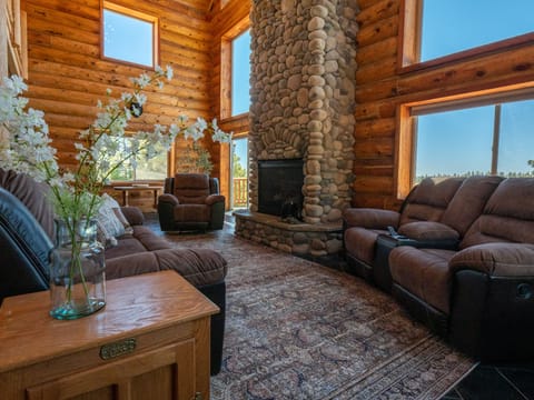 Family room with lounging chairs, gas fire place, and views from all sides.