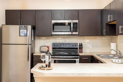 Spacious kitchen with lots of counter space, stainless steel appliances, and tons of kitchenware! You'll have everything you need to cook a gourmet meal.