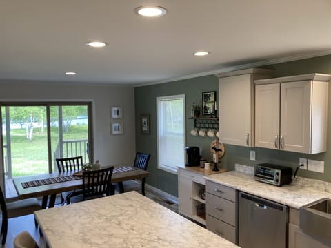 View of kichen/dining area out to the front porch area to river
