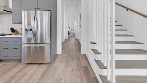 Entry to first floor primary, powder room, and laundry room