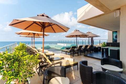 Outdoor pool, open 7 AM to 10 PM, pool umbrellas, sun loungers