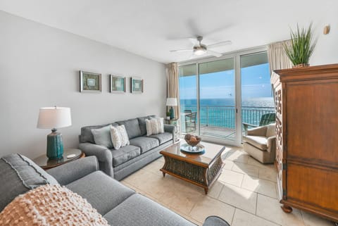 Relax in your bright living room with stunning ocean views through floor-to-ceiling windows and step out to your private balcony.