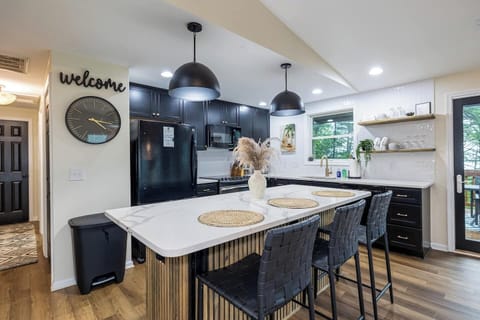 Stylish and open kitchen with Quartz Countertops, tiled backsplash, updated appliances, fully stocked kitchen