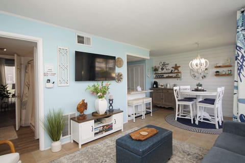 Step into your coastal retreat where soft blues meet crisp whites, creating a serene open-plan sanctuary perfect for relaxing.