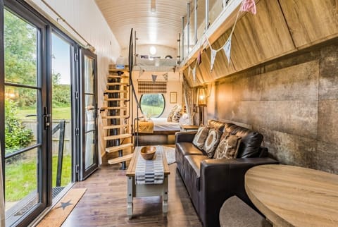 Step inside to open-plan living with a clever spiral stair leading up to the kids` den.
