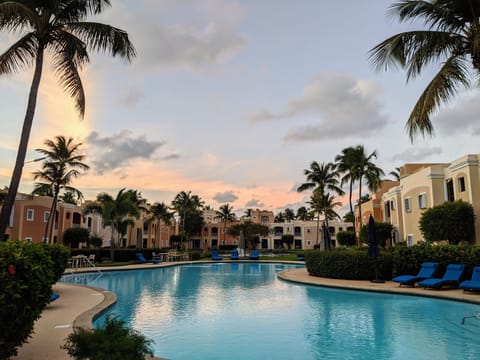 Relax in our complex with a crystal clear pool surrounded by lush palm trees.
