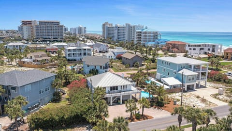 Elevated neighborhood view w/ rooftops, streets, & a coastal vibe