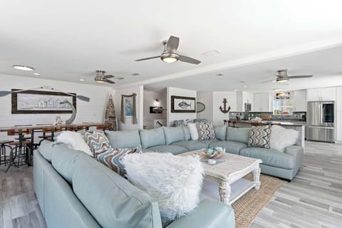 Bright living room w/ plush seating, coastal accents, & an open, relaxed layout