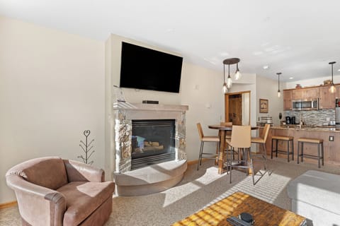 Sink into comfort in your inviting living area, where warm wood tones and a cozy fireplace create the perfect atmosphere for relaxation.