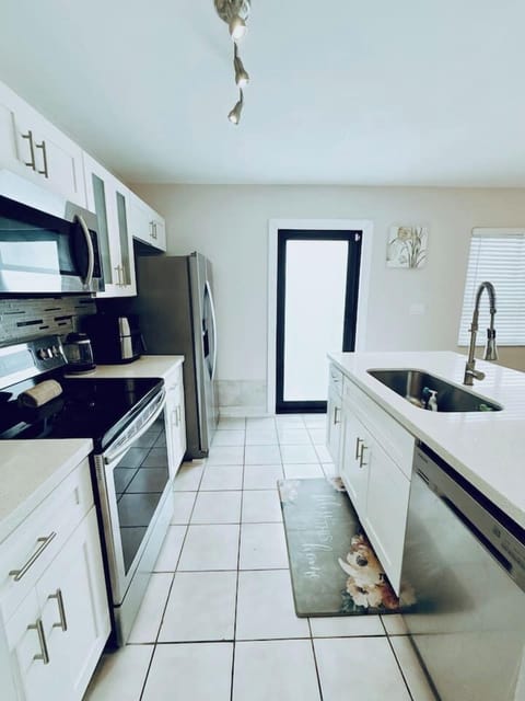 Open Concept Kitchen with Stove top oven, Microwave and Dishwasher