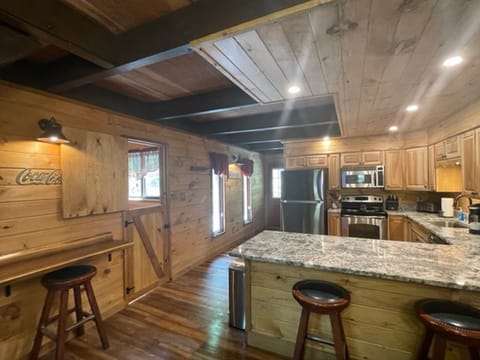 Past the frig is the front door and the split door goes downstairs to a king bed