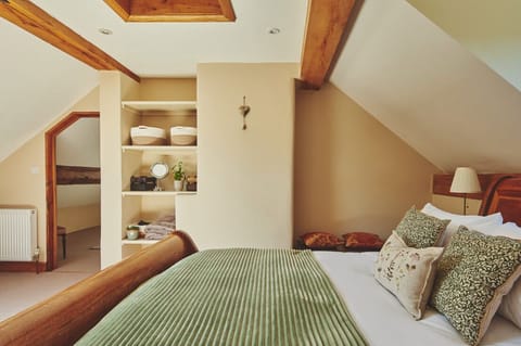 Spacious master bedroom with traditional oak beams