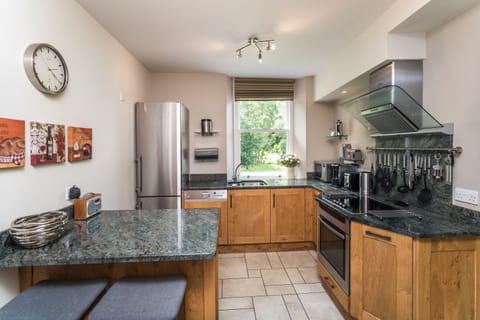 The fitted kitchen has fridge, freezer, electric oven and hob, microwave oven, washing machine and tumble dryer