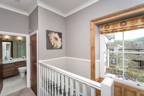 The stairs lead to the hallway, with views over the large courtyard